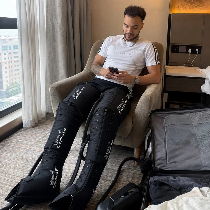Home-M010_Man_Relaxing_with_Leg_Compression_Boots_in_Hotel_Room_-Pages-EMICOOL
